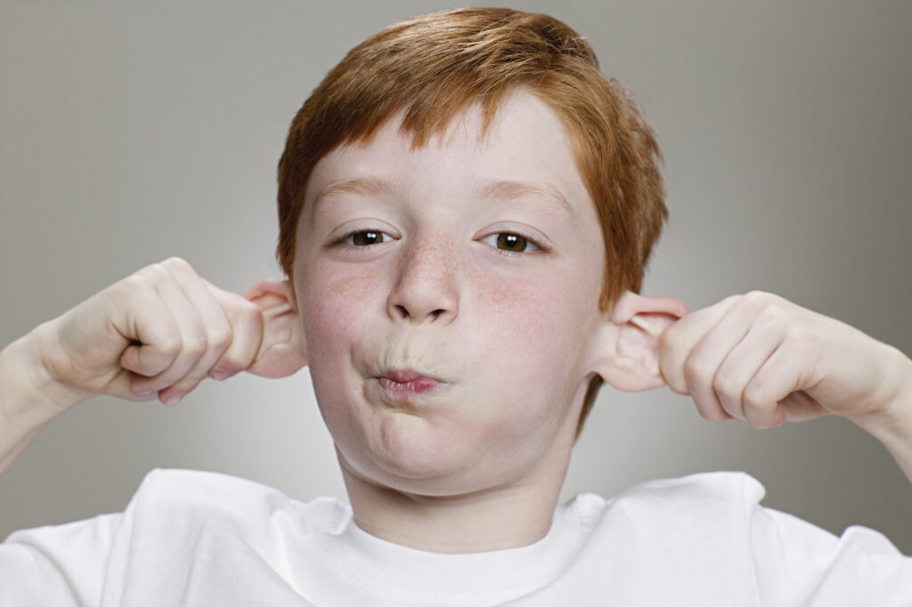 boy pulling ears